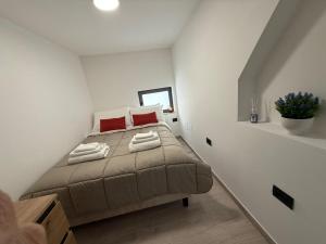 a bedroom with a bed with red pillows at A Volte nel Salento-Porta Napoli in Lecce