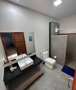 a bathroom with a sink and a toilet at Flat amplo a 50m da praia em Barra Grande in Barra Grande