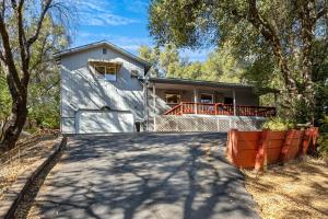 a large white house with a large driveway at Yosemite Falls Calling in Groveland