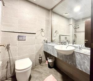 a bathroom with a toilet and a sink at Al Manara Premium Cozy Studio in Dubai +7 photos