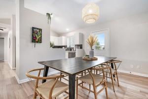 a kitchen and dining room with a table and chairs at Elegant Escape-Fenced Yard BBQ & Cozy Fire Pit in Omaha