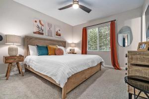 a bedroom with a large bed and a window at Elegant Escape-Fenced Yard BBQ & Cozy Fire Pit in Omaha