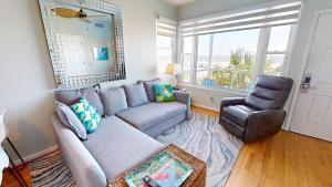 a living room with a couch and a chair at The One in Folly Beach