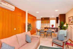 a living room with a couch and a table at Executive Townhouse, Tavira Centre, Shared Pool in Tavira