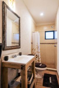 a bathroom with a sink and a toilet and a mirror at Cabaña en el Ajusco, experiencia única en la naturaleza in Caseta Forestal
