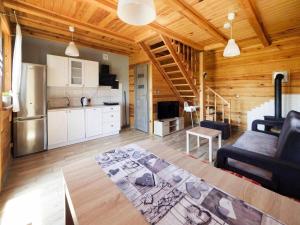 a kitchen and living room with a couch and a table at House in Niechorze near Baltic Sea Beach in Niechorze