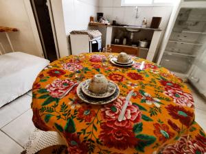 a table with plates and bowls on top of it at Hospedagem da Lu in Paraty +25 photos