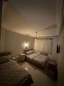a hotel room with two beds and a window at Mk Big boss otel in Erzurum +4 photos