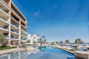 an image of a swimming pool at a resort at 2 Bedroom Residence with Terrace & Grill Live Aqua La Paz in La Paz