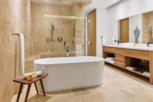 a large bathroom with a tub and a shower at 2 Bedroom Residence with Terrace & Grill Live Aqua La Paz in La Paz