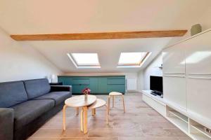 a living room with a couch and a table at Studio rénové et fonctionnel in Bron