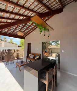 a kitchen with a black table and wooden ceiling at Casa bem localizada em BG in Barra Grande