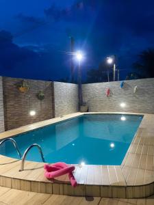 a swimming pool at night with a large blue pool at Lucena House in Lucena