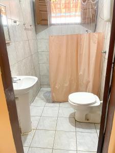 a bathroom with a toilet and a sink at Lucena House in Lucena