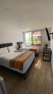 Postel nebo postele na pokoji v ubytování Samalá Casa Hotel
