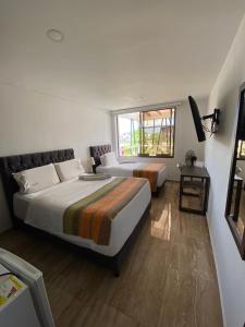Postel nebo postele na pokoji v ubytování Samalá Casa Hotel