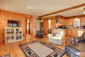 a living room with a couch and a stove at Cozy Cabin with Private Dock on Fifth Crow Wing Lake in Nevis +16 photos