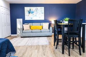 a living room with a couch and a table and chairs at NEW5 LUXURYSTUDIO Nr DISNEY PETSOKprivENTRY in Kissimmee +19 photos