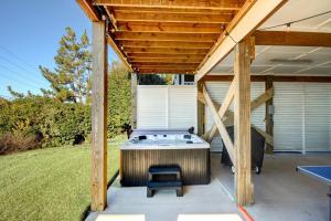 an outdoor hot tub under a wooden pergola at Ocean Sounds in West Onslow Beach