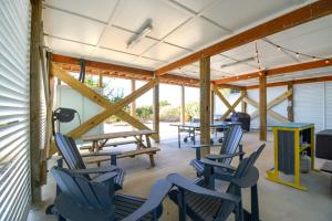 a room with blue chairs and a picnic table at Ocean Sounds in West Onslow Beach