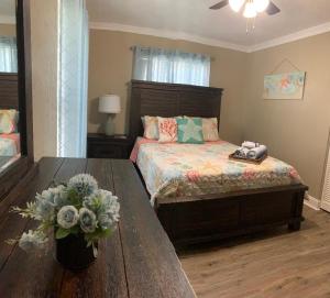 a bedroom with a bed and a table with flowers at Tropical Oasis 10th in Bradenton +24 photos