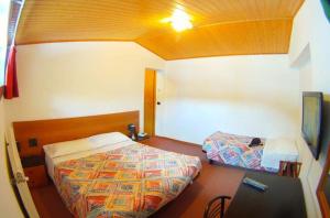 Postel nebo postele na pokoji v ubytování Hotel Canin