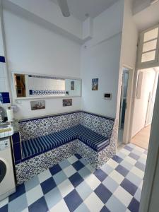 a room with a bench on a tiled floor at BALKIS La RÊNE DE SABA in Sidi Bou Saïd
