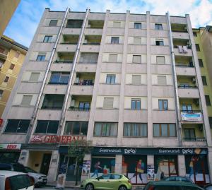 a tall building with cars parked in front of it at Suite Isernia Centro in Isernia