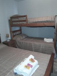 a bedroom with two bunk beds with white towels at Cafayate Suite in Cafayate