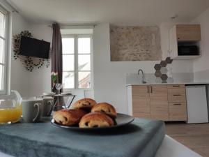 a plate of bagels on a table in a kitchen at Studio Kamelia in Saint-Aignan +4 photos