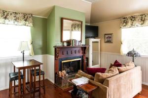 a living room with a couch and a fireplace at Headlands Inn Bed and Breakfast in Mendocino