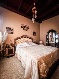 a bedroom with a large bed and a chandelier at ORHO HOTEL BOUTIQUE PANAMA Tocumen Airport free shuttle highway round trip 15 minuts in Tocumen