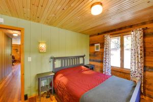 a bedroom with a bed in a room with wooden walls at Idyllic Twin Lakes Escape with Deck and Fire Pit! in Twin Lakes +30 photos
