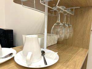 a table with a blender and plates and wine glasses at La Vetere House in Catania +19 photos