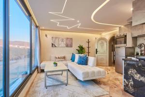 a living room with a couch and a table at Amwaj Apt - Beachfront Paradise Charming 1BR with Ocean Views in Mirleft