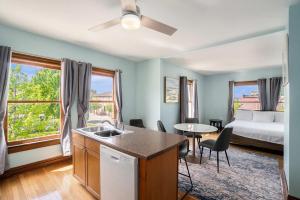 a room with a bed and a kitchen with a sink at Grand Harbor Apartments 3 - 200 in Grand Haven