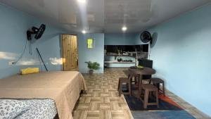 a bedroom with a bed and a table in it at Osa House with Pool and Air-Conditioning in Puerto Jiménez