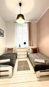 Łóżko lub łóżka w pokoju w obiekcie Beautiful Rooms - Wały Chrobrego