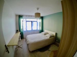 a small bedroom with a bed and a window at Charming & cosy rooms Nantes (chambres chez l'habitant) in Nantes