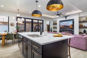 a kitchen and living room with a purple couch at Wild West Oasis - Experienced Hosts, 2 King Suites in Hurricane