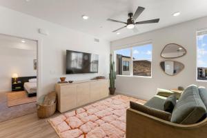 a living room with a couch and a ceiling fan at The Way Station condo in Hurricane +31 photos