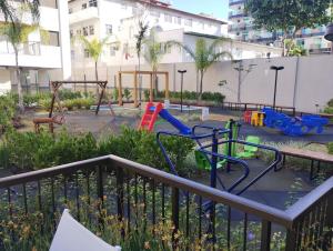 a park with a playground with swings at Apartamento Completo em Cabo Frio in Cabo Frio