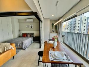 a room with a bed and a table with a plate on it at Edição Jardim Paulista in Sao Paulo +75 photos