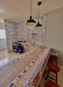 a kitchen with a table and two stools at 01 Apartamento Mandacaru in Caruaru