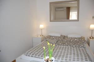 ein Schlafzimmer mit einem Bett mit einem Spiegel und 2 Lampen in der Unterkunft Budapest Downtown Apartments with Balcony & optional Garage & Restaurant in the building in Budapest