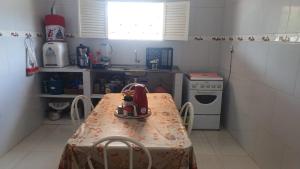 a kitchen with a table with a tea kettle on it at Recanto do Ze Bonito in Conde +5 photos