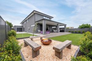 a house with a garden with benches in the yard at Rigby Retreat at St Leonards in Saint Leonards