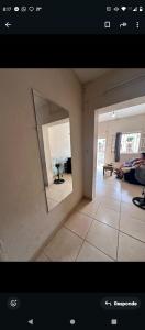 a view of a living room with a mirror at Alojamiento Artigas in Artigas +3 photos