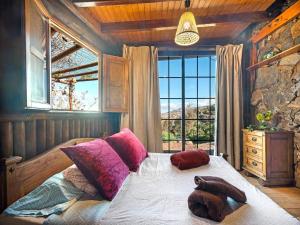 a bedroom with a bed with a stuffed animal on it at Holiday Home in Tenerife with Private Garden in La Corujera