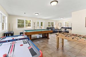 a living room with a pool table and billards at Swan Shores-Expansive Lakefront Home with Private Dock in Grand Junction